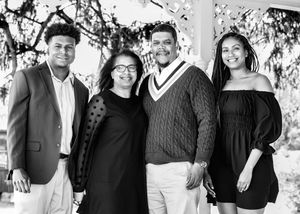 A black and white panoramic collage showing a group of people posing together in casual attire.