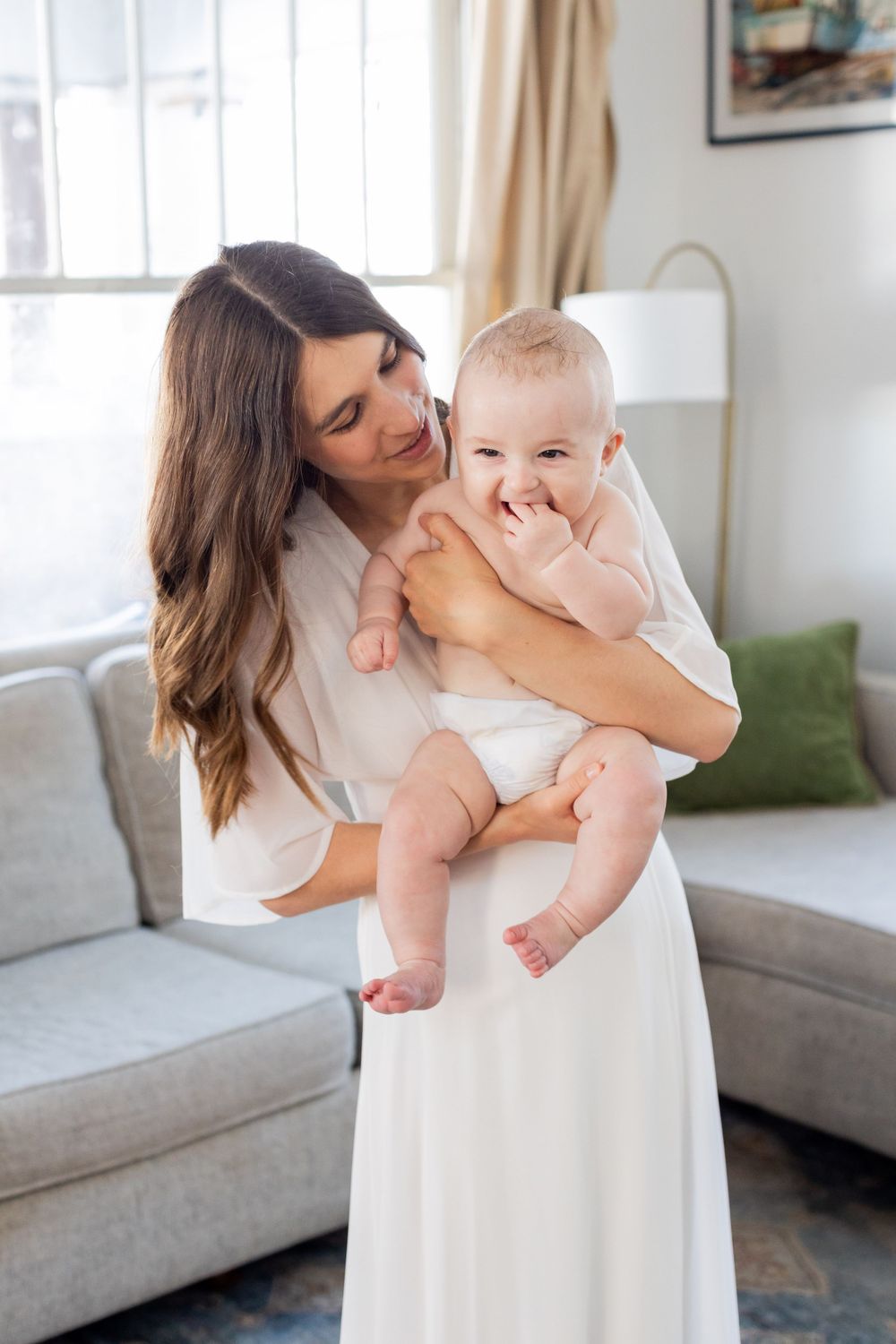 Tender moment between parent and baby in a sunlit living room in Springfield, Missouri.