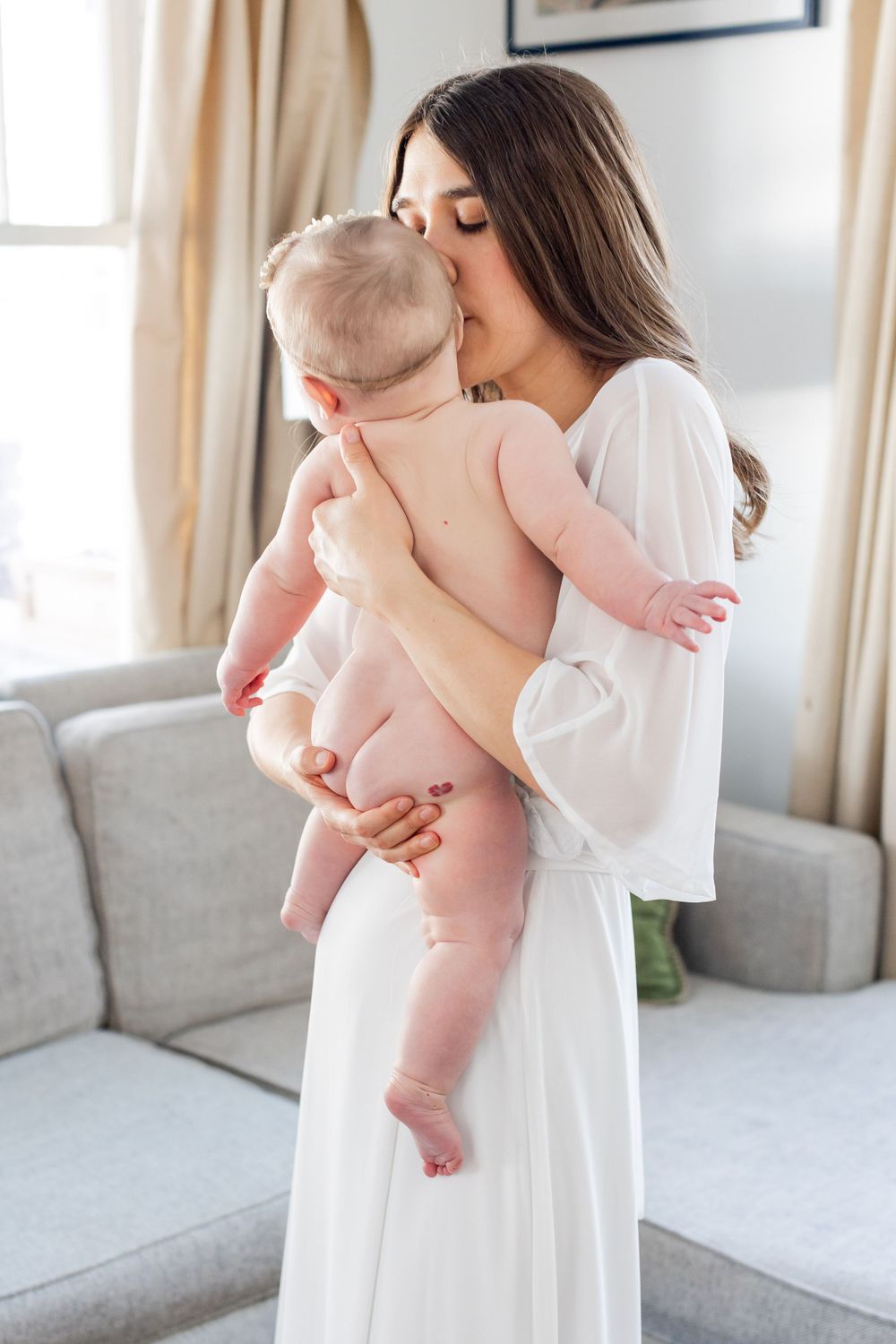 Tender moment captured in sunlit room of a mother and baby in Springfield, Missouri.