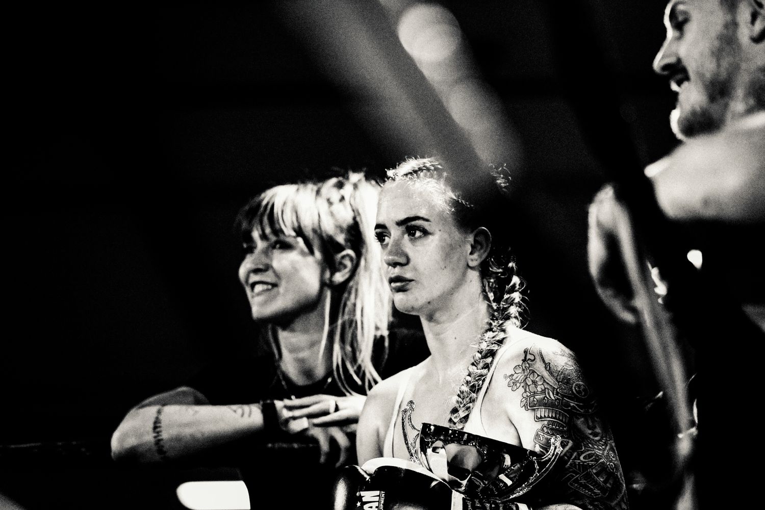 Black and white performance photo of a punk rock band members on stage in dramatic lighting.