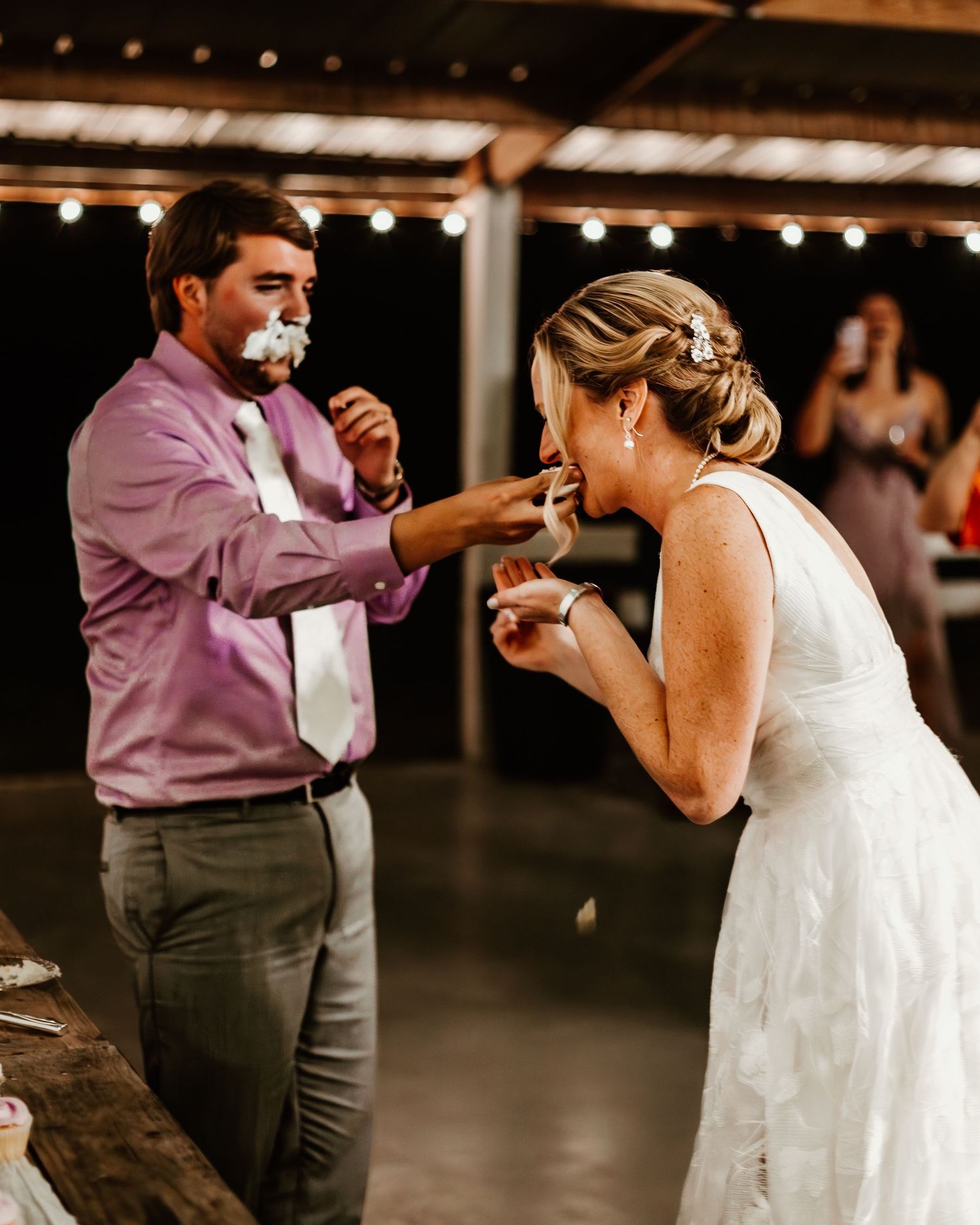Reception venue with string lights and cozy indoor atmosphere for dancing and celebration.