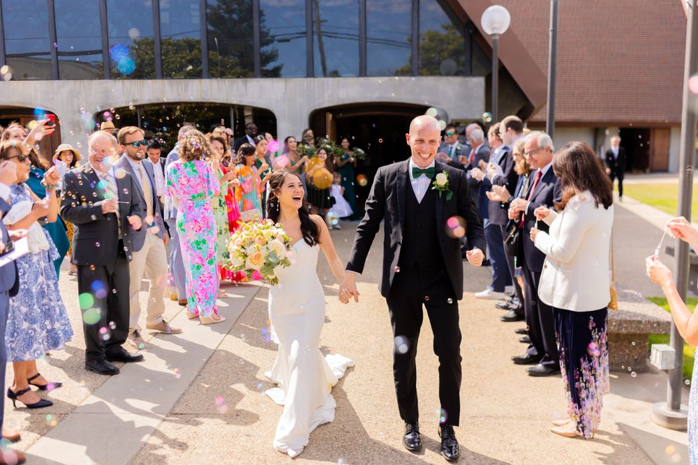 Wedding guests line up outside to create a celebratory exit pathway.