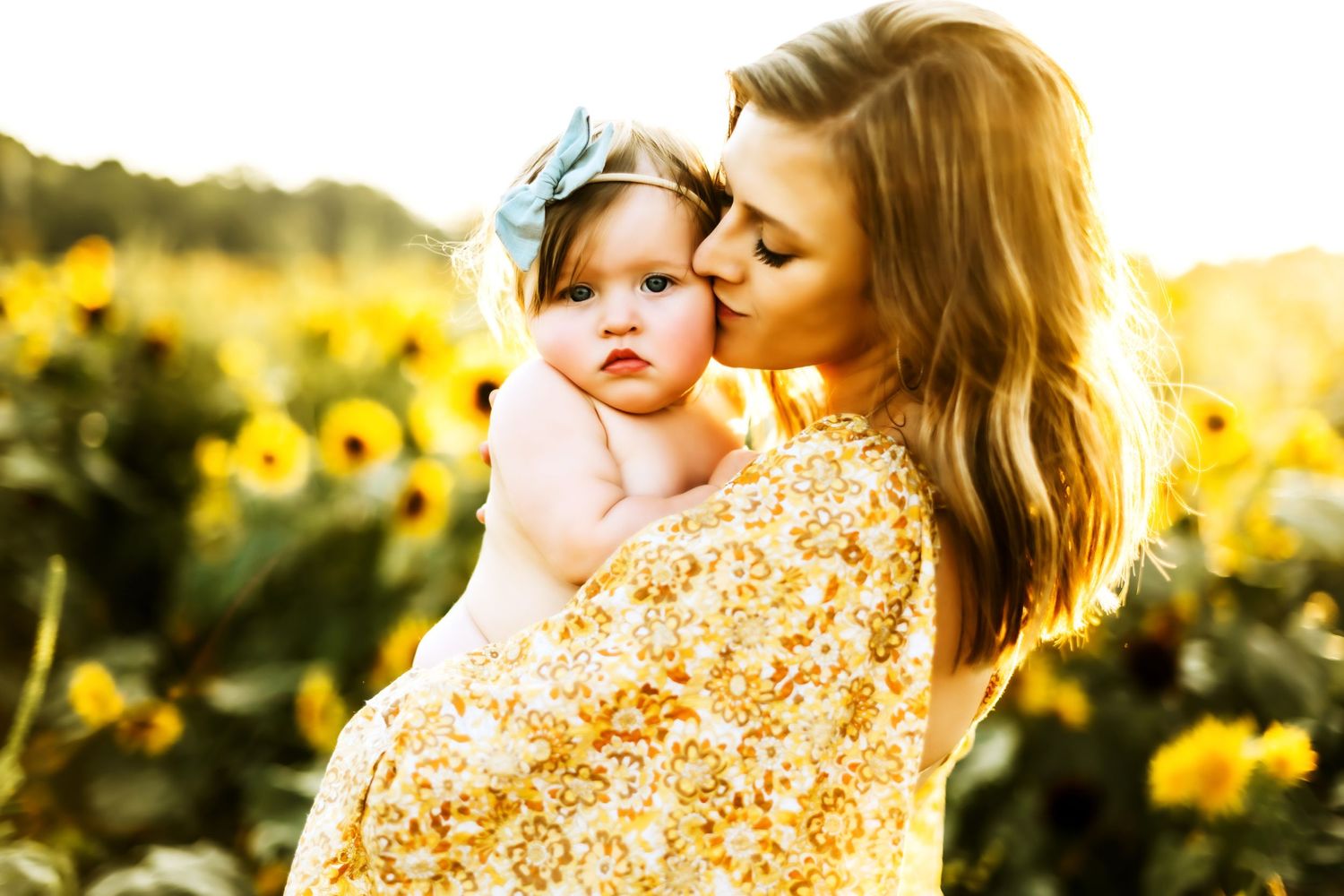 A heartwarming moment captured in a sunflower field at golden hour with a flowing yellow floral dress.