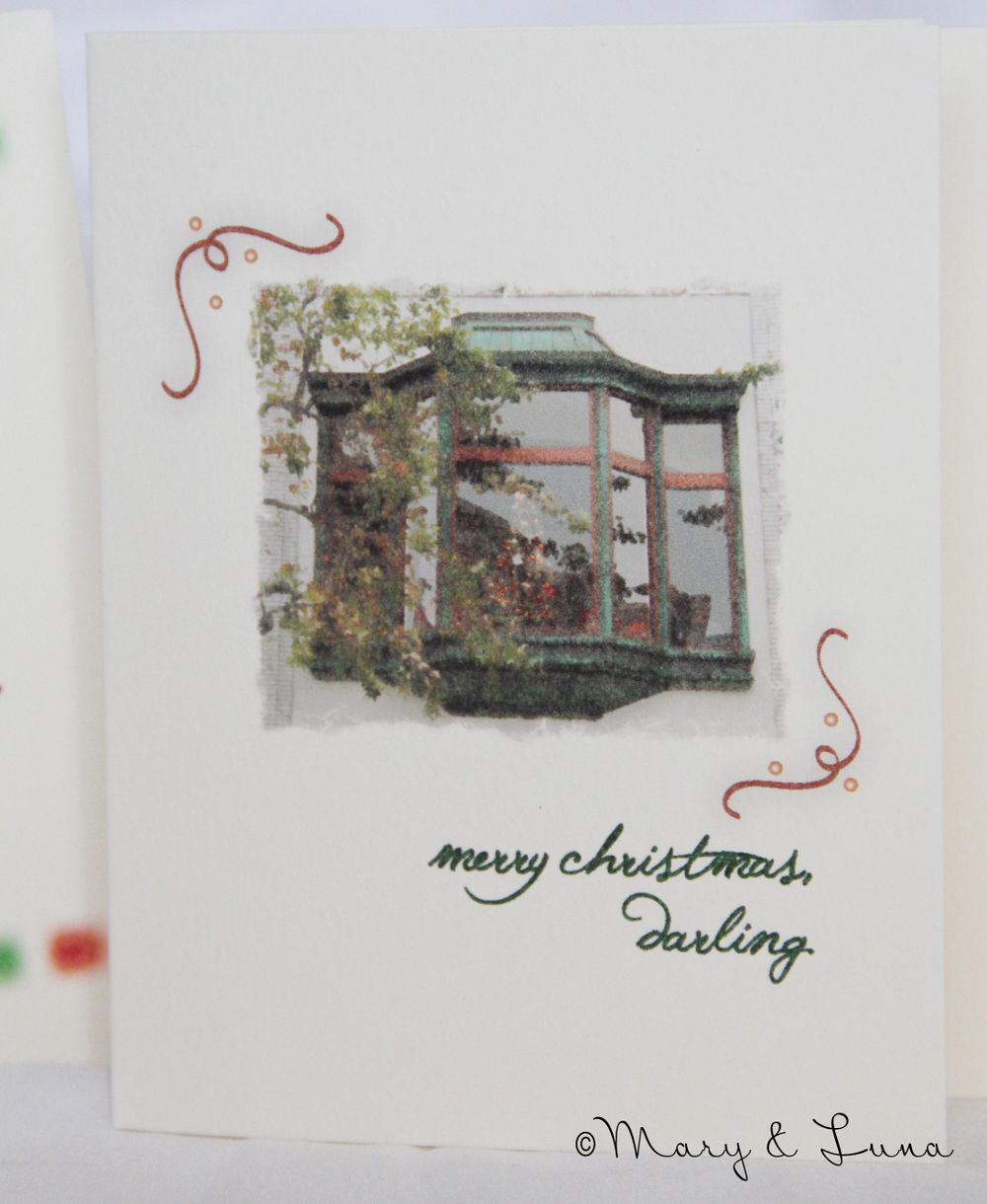 christmas card with a photo of a shop window on it. underneath are the words "merry christmas, darling"
