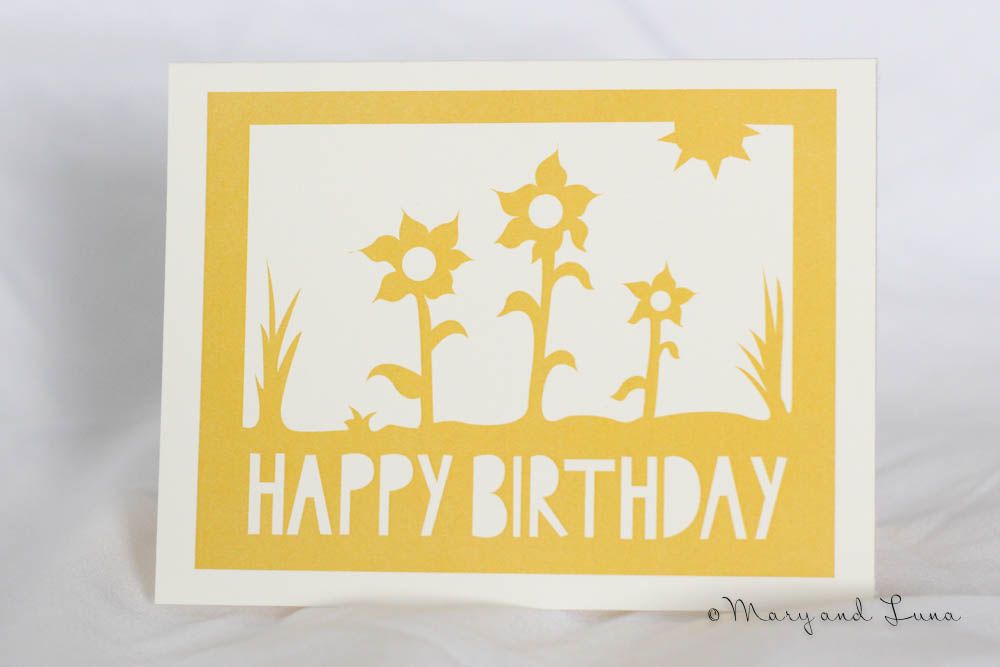greeting card with digital art of yellow sunflowers. cutout text says says "happy birthday"