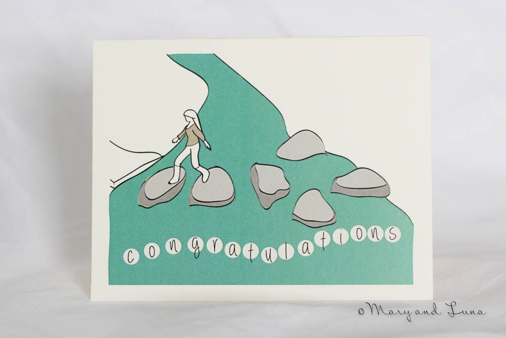 greeting card with digital art illustration of girl walking across rocks over a stream. underneath says "congratulations"