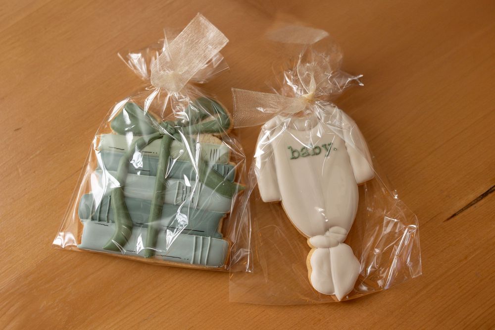 Light blue party favors wrapped in clear plastic bags.