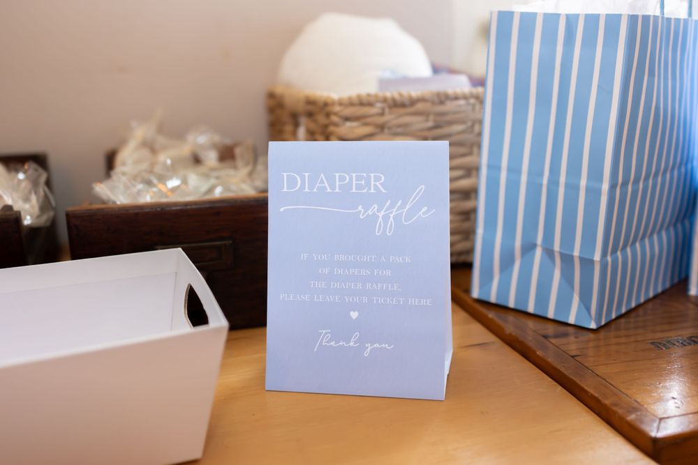 Light blue and white striped gift boxes arranged in a row on a wooden surface.