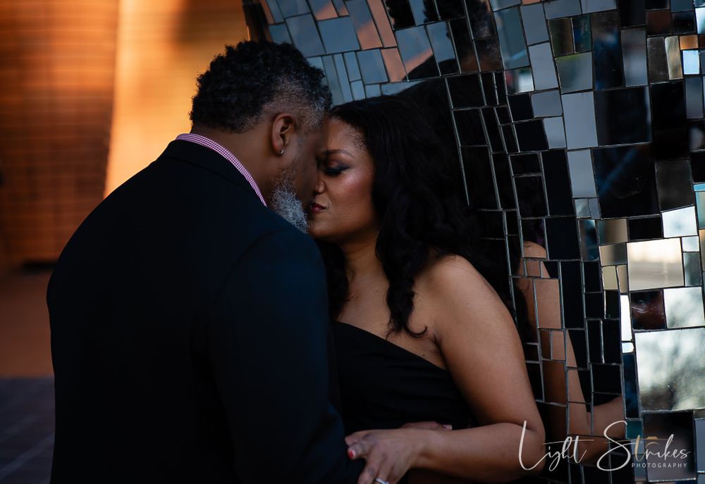 Intimate couple embraces in romantic lighting during elegant evening photoshoot captured by wedding photographer in Charlotte.
