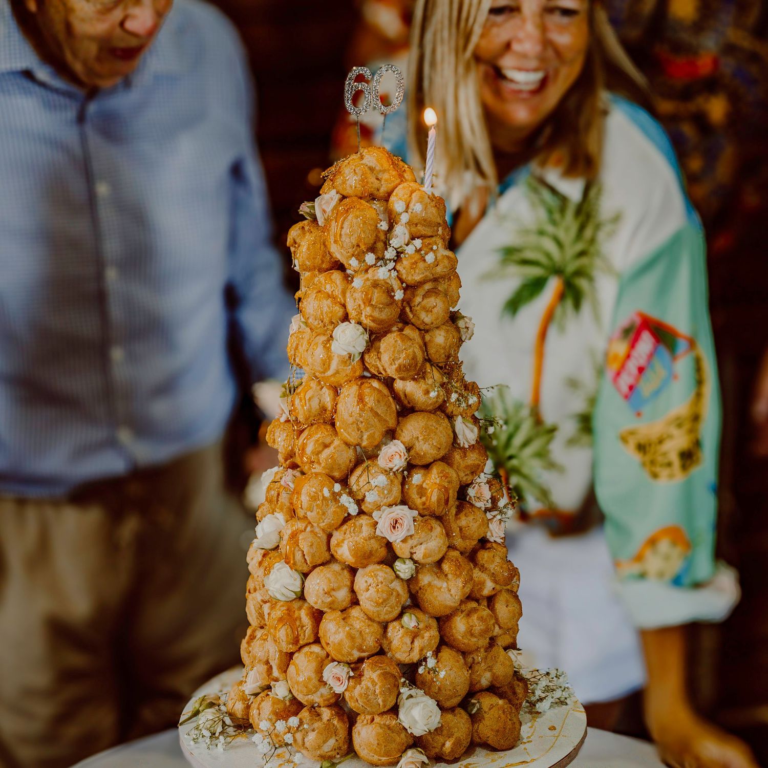 Tall croquembouche dessert tower of cream puffs displayed at celebration.