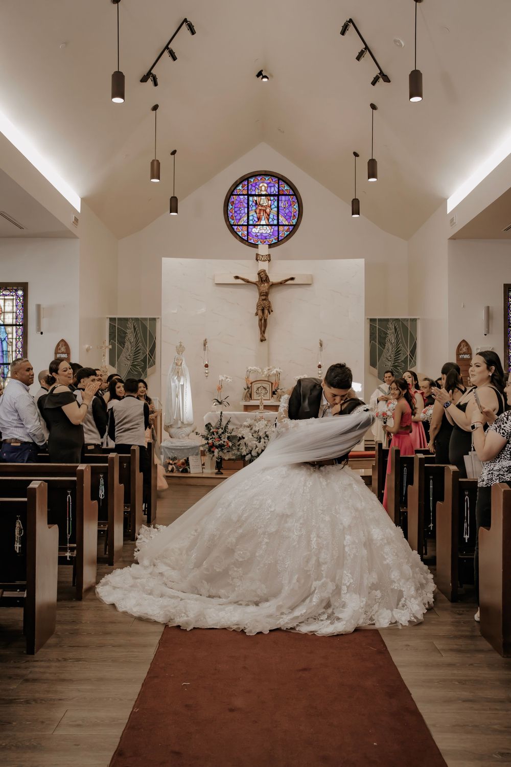 Groom dips bride for a kiss after wedding ceremony
