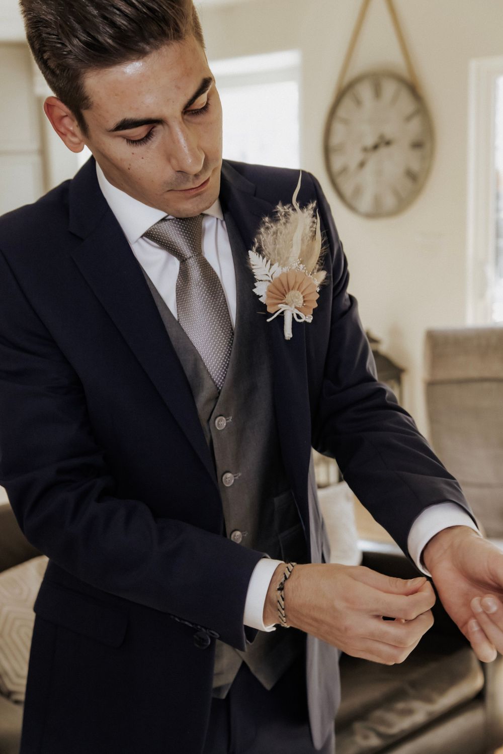 Groom fixing his shirt before the ceremony