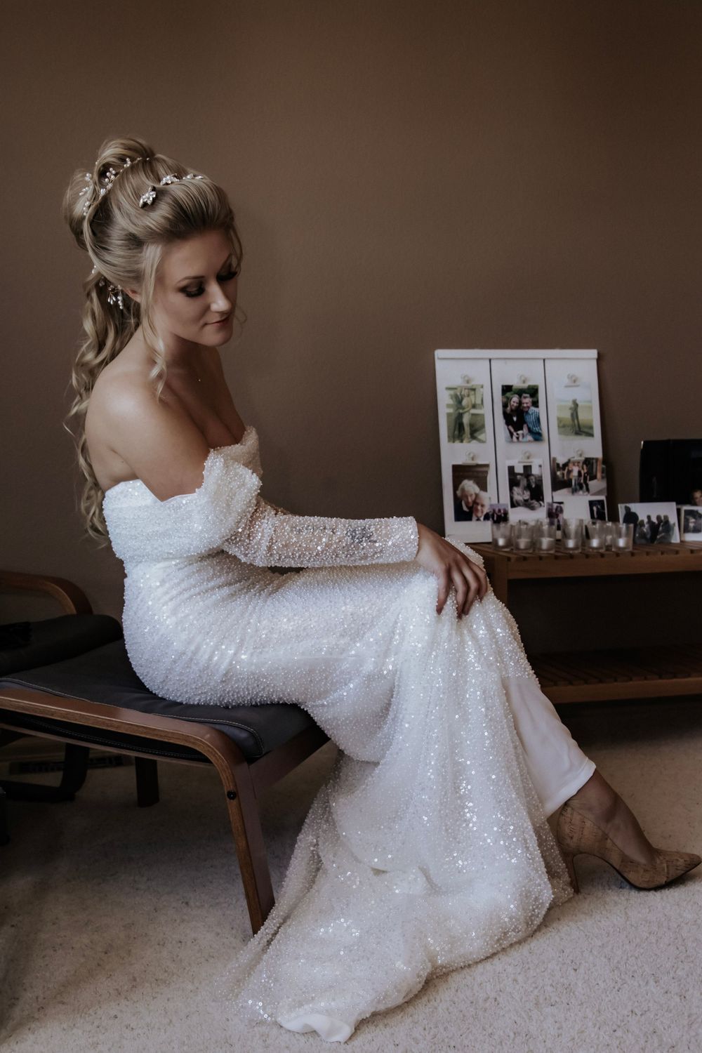 Bride sits in a chair in her wedding dress and shoes
