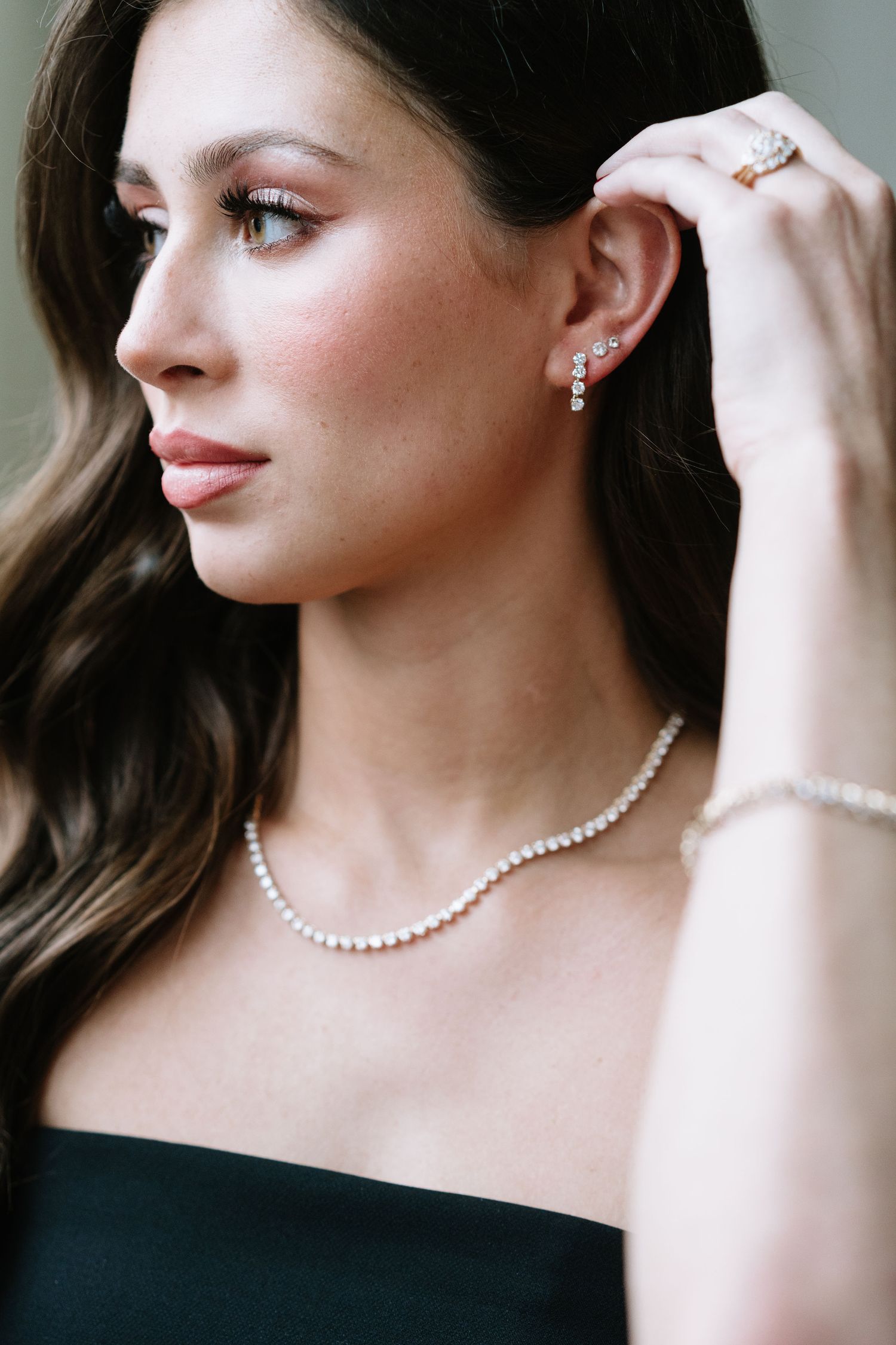 Elegant pearl necklace and earrings styled with a classic black evening dress.