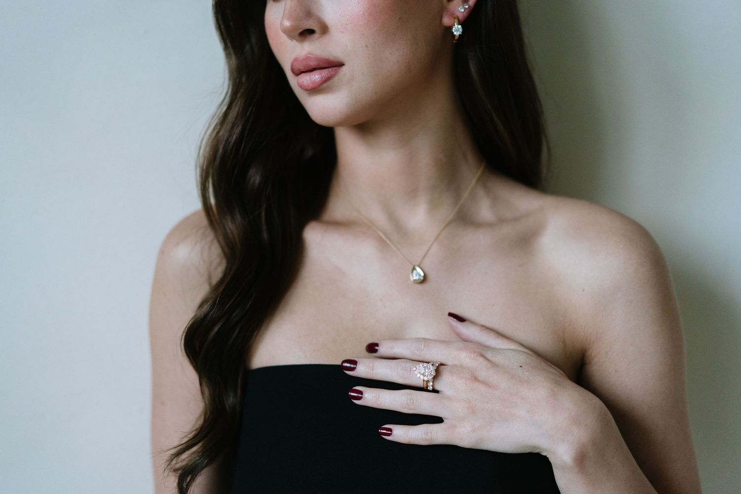 Fashion detail shots of jewelry and accessories styled against dark clothing.