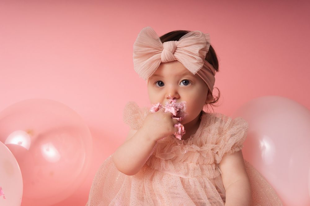 Romantic pink-toned portrait photography series with soft lighting and delicate bow accessories against rosy backdrop.