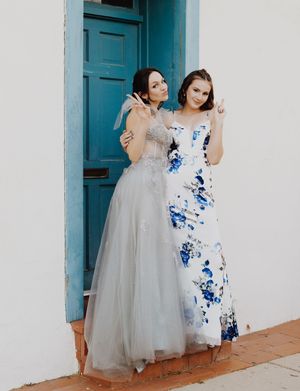 Fashion portraits featuring formal dresses in white and blue against colonial architecture.