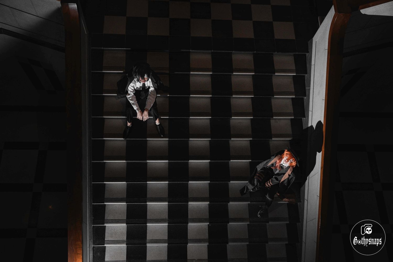 A dark moody series of photos showing  2  Bsd Cosplayers in shadows against a black background with dramatic lighting.