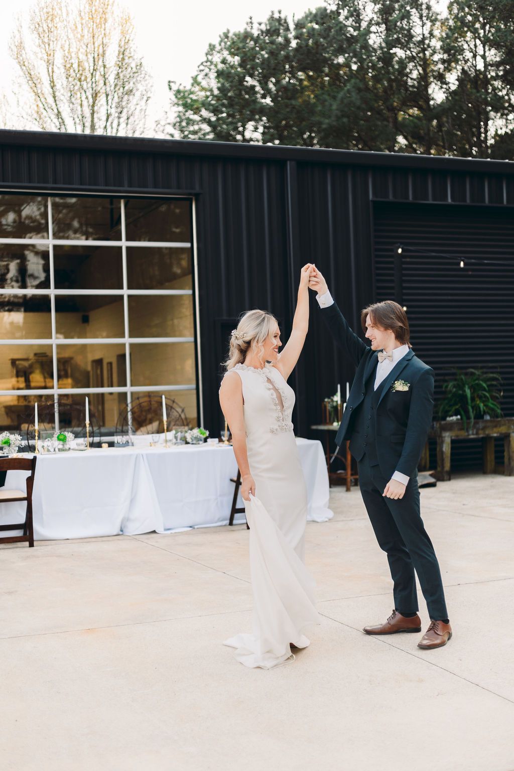 Couple having first dance at wedding reception on shaded patio at Sanctuaire Atelier.