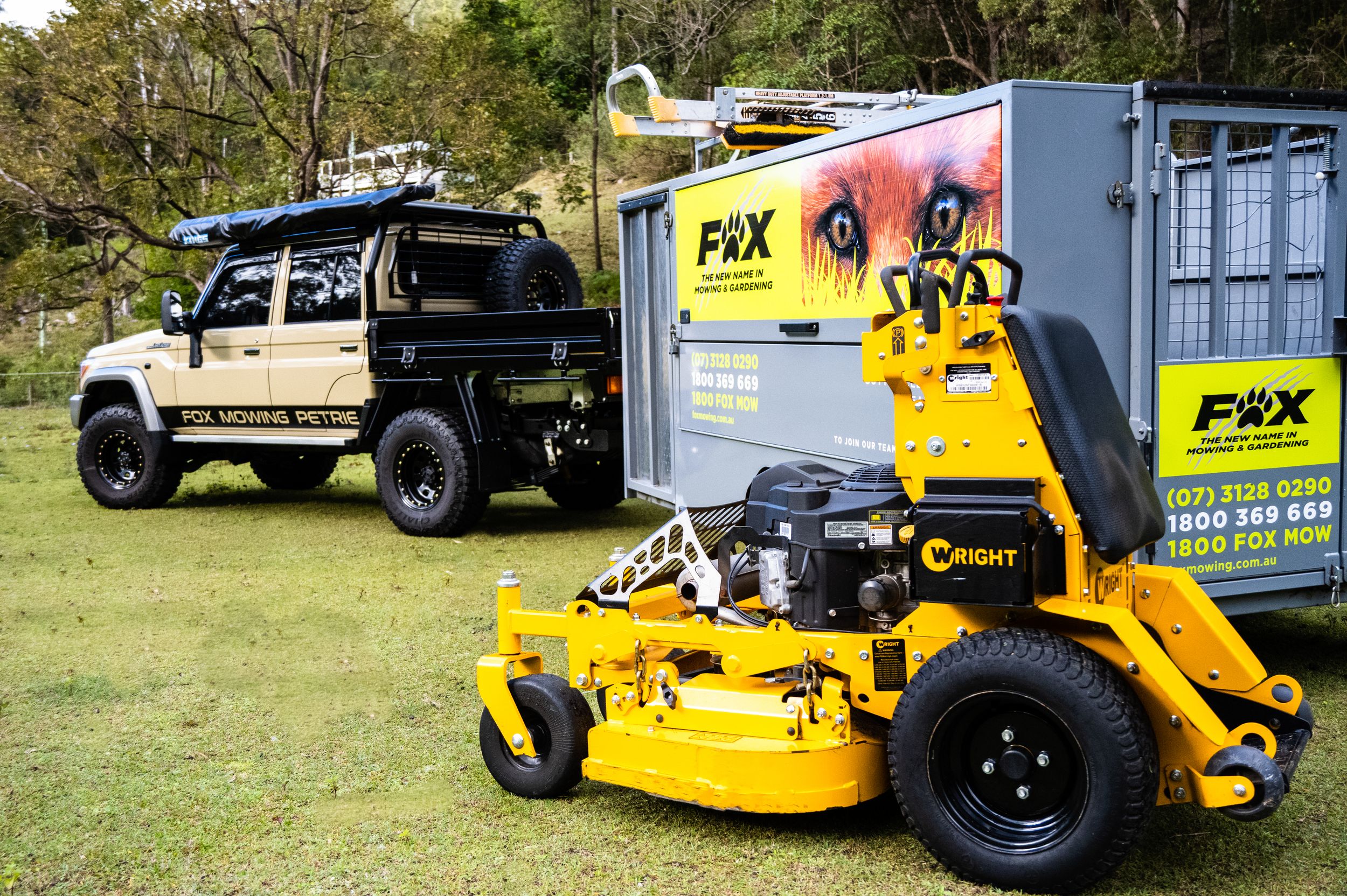 Commercial landscaping equipment including yellow mowers on display outdoors.