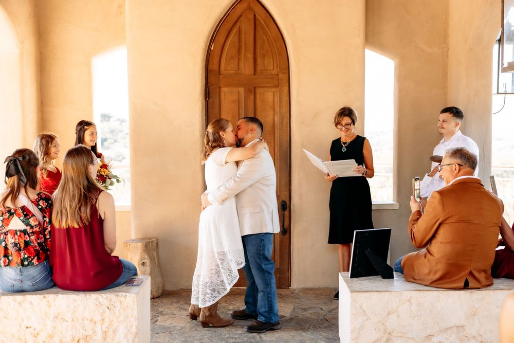 A series of romantic engagement photos captured in a rustic stone hallway with natural window lighting.