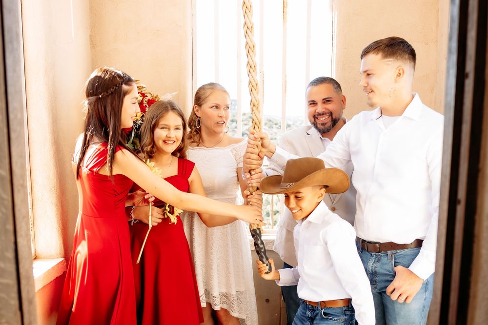 A group in red and white attire celebrates joyfully together in a bright indoor setting.