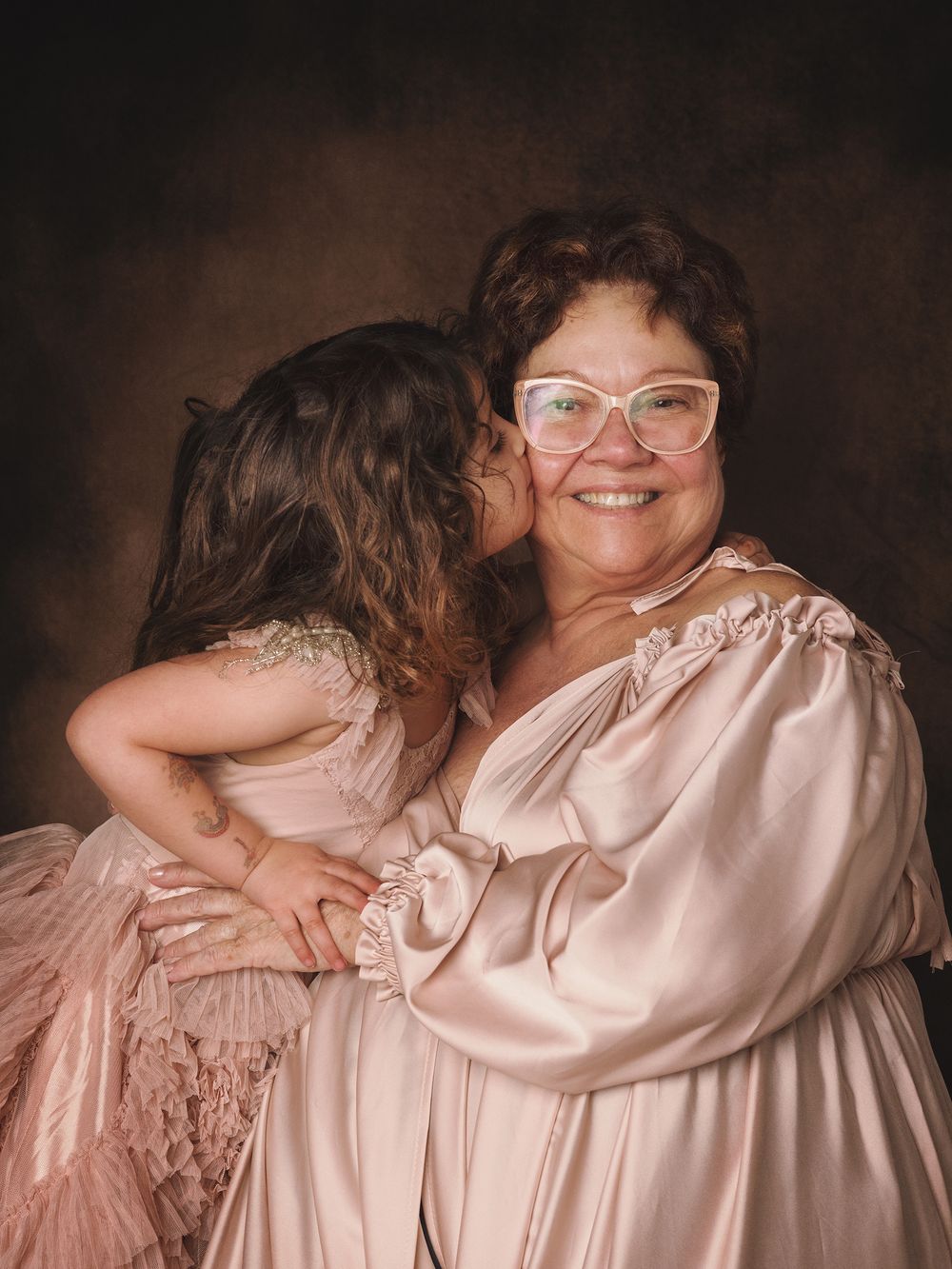 A heartwarming series of intimate embraces between family members shown in a vintage-style brown toned portrait sequence.