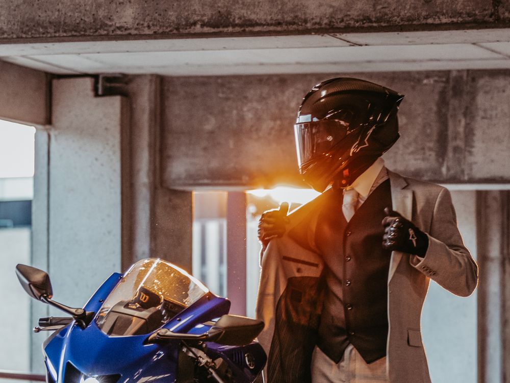 Two welders work in a construction environment wearing protective gear and using welding equipment.