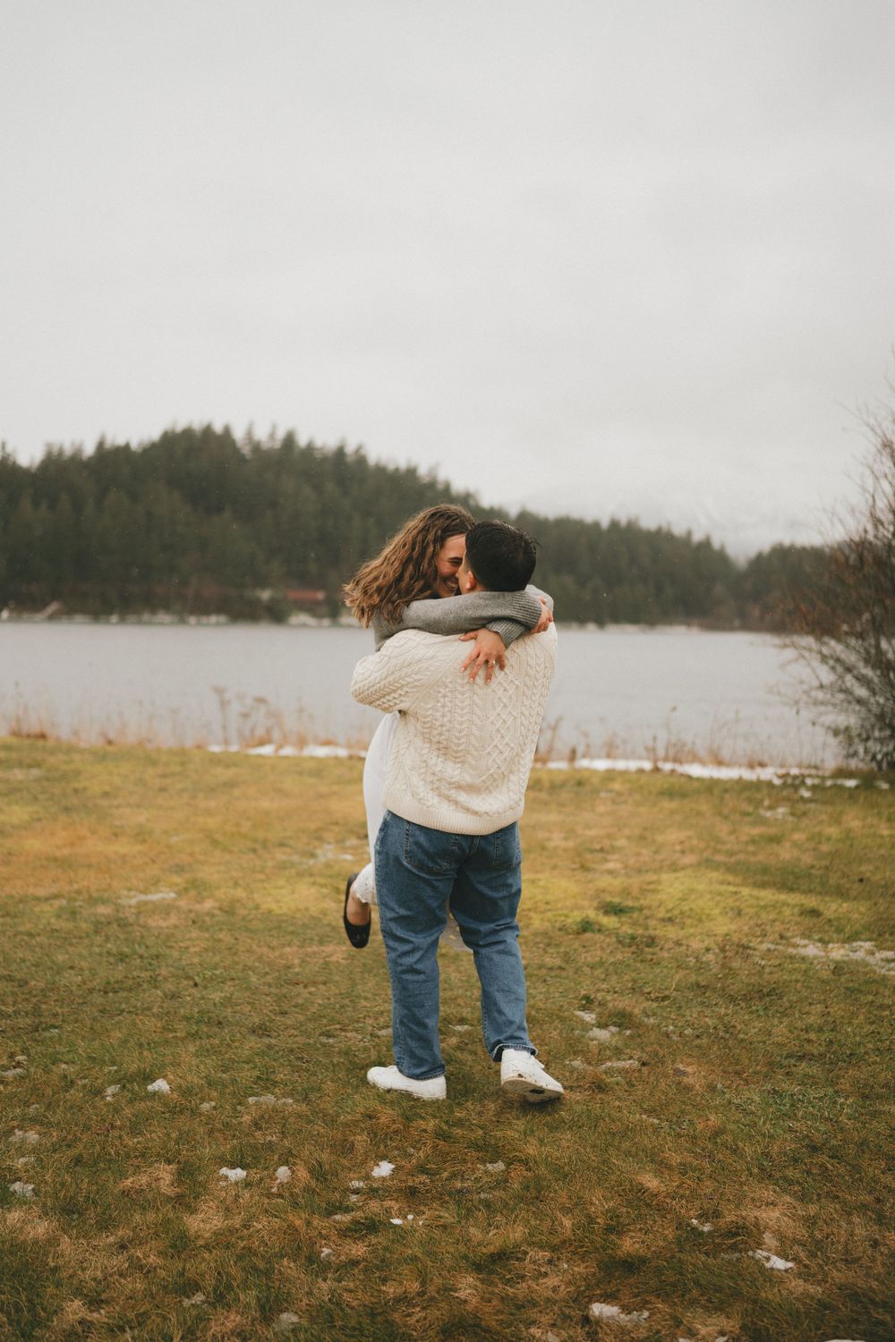 Candid shots of joyful movement and laughter in an autumn field by the water.