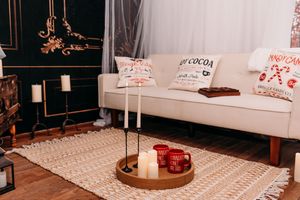 Modern living room interior with white sofa, patterned rug, and decorative table lamp creating a cozy atmosphere.