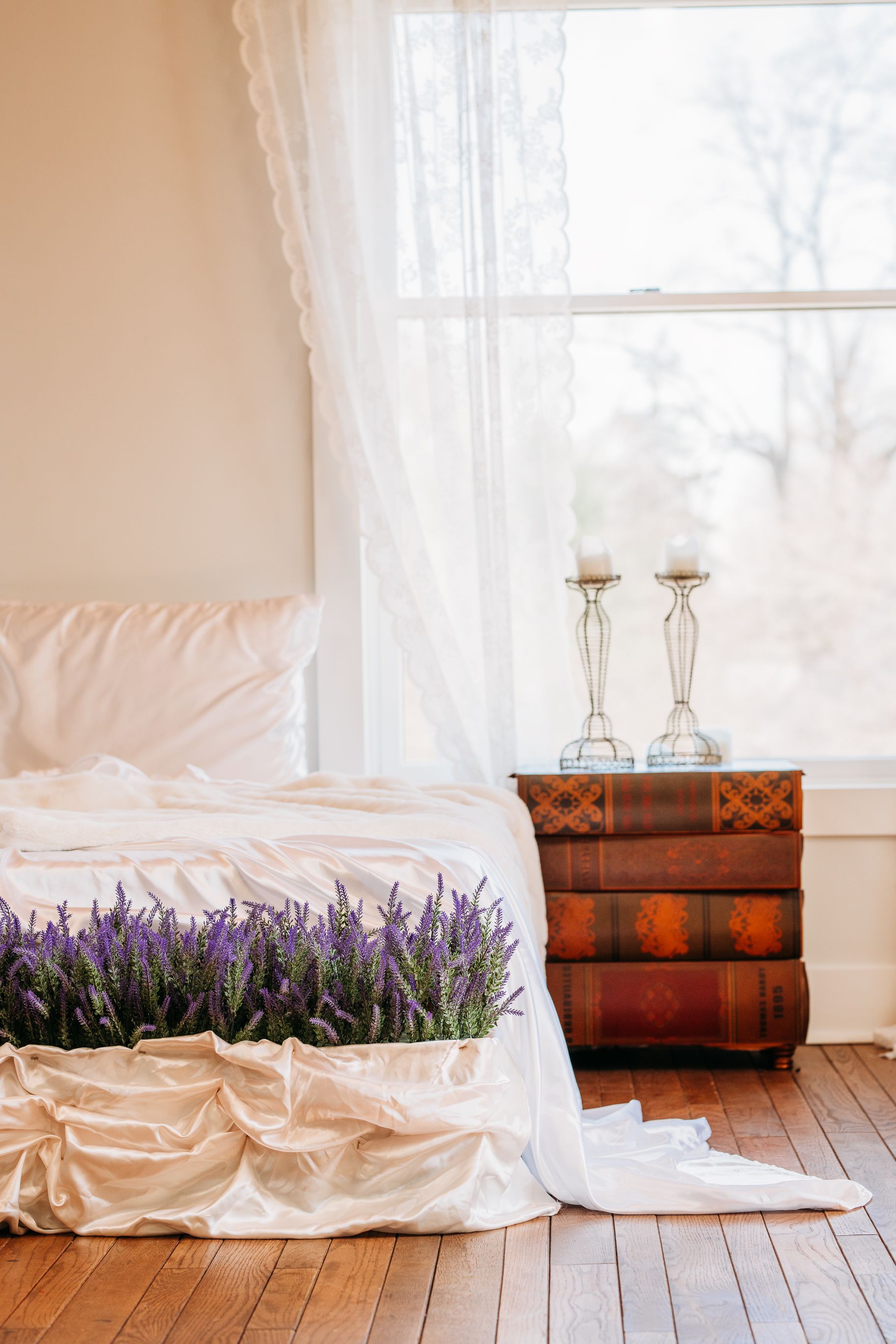 Four connected interior photos showing lavender flowers in wooden barrels on a hardwood floor next to white linen drapes. Photography Studio