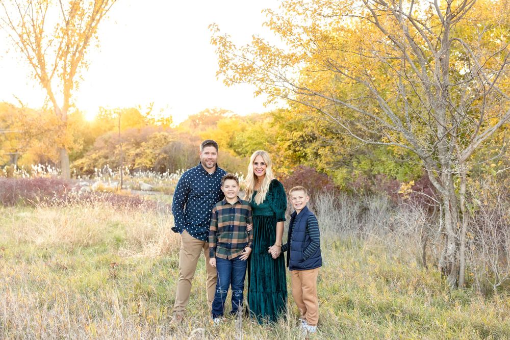 Extended family photo shoot in a rustic outdoor setting during golden hour. Clear Lake Photographer. Mason City Photographer.
