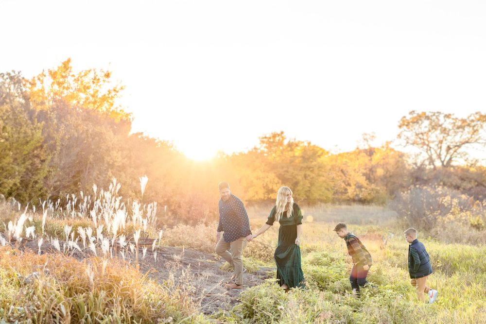 Candid family photo session in a golden autumn field at sunset. Clear Lake Photographer. Mason City Photographer.