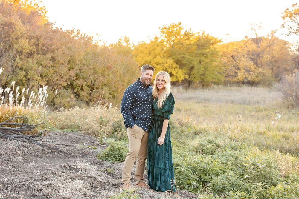 Family gathering for outdoor photos in nature during sunset.
