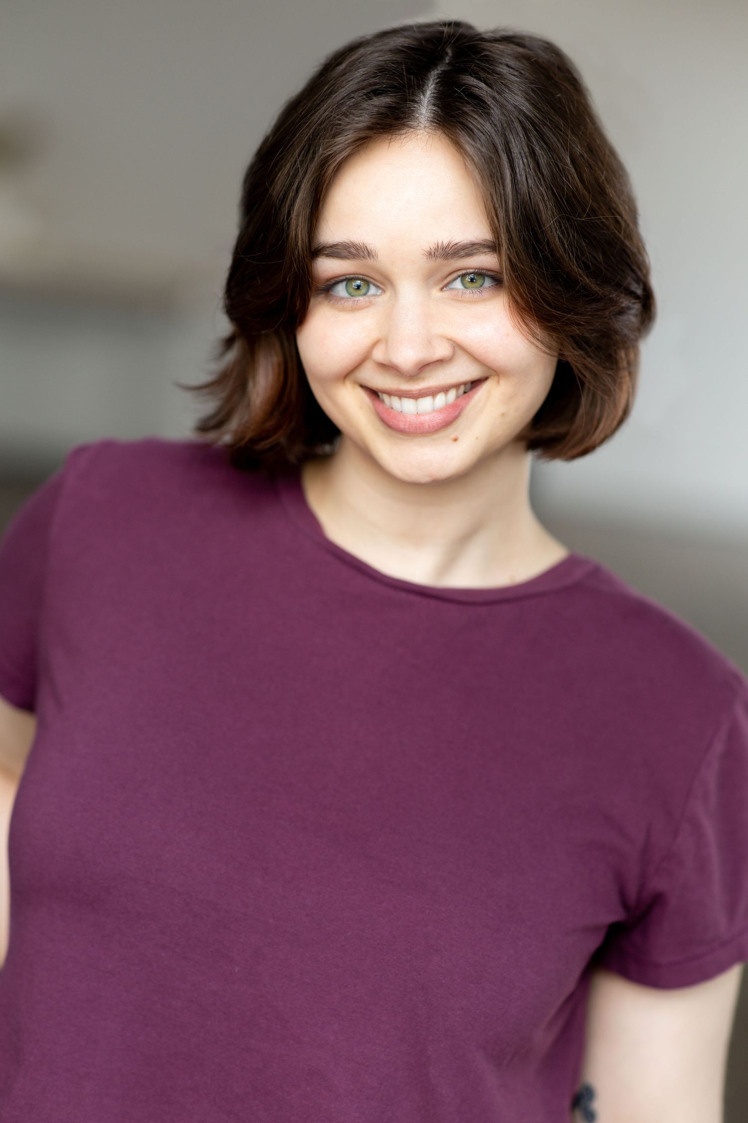 Studio portrait with soft lighting showing a warm smile against neutral background. Twin Cities headshots.