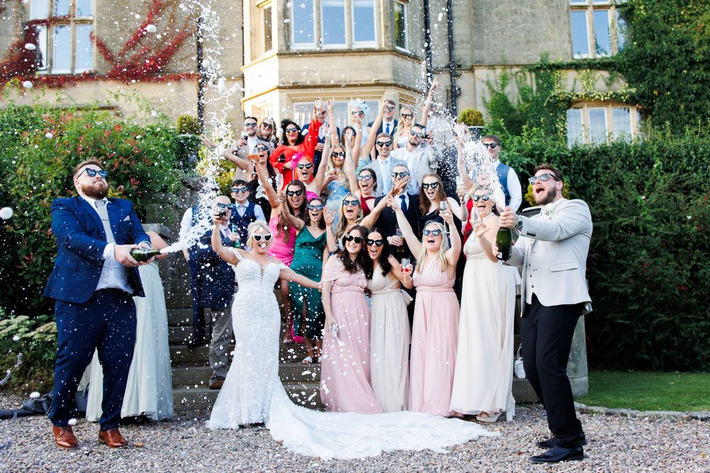 wedding photographer photography couple champagne spray at falcon manor  Greater Manchester Tameside