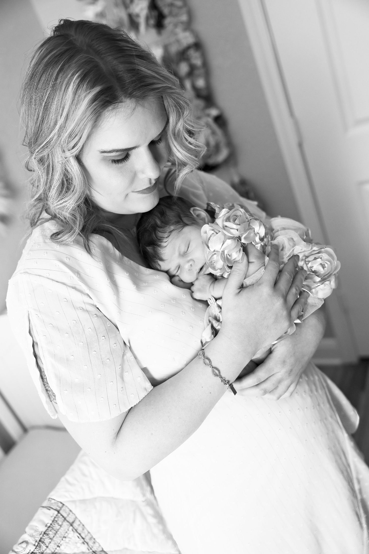 In home newborn lifestyle session. Mom holding baby in nursery. New Mexico Newborn photographers. Baby photographer. Roswell NM photographer
