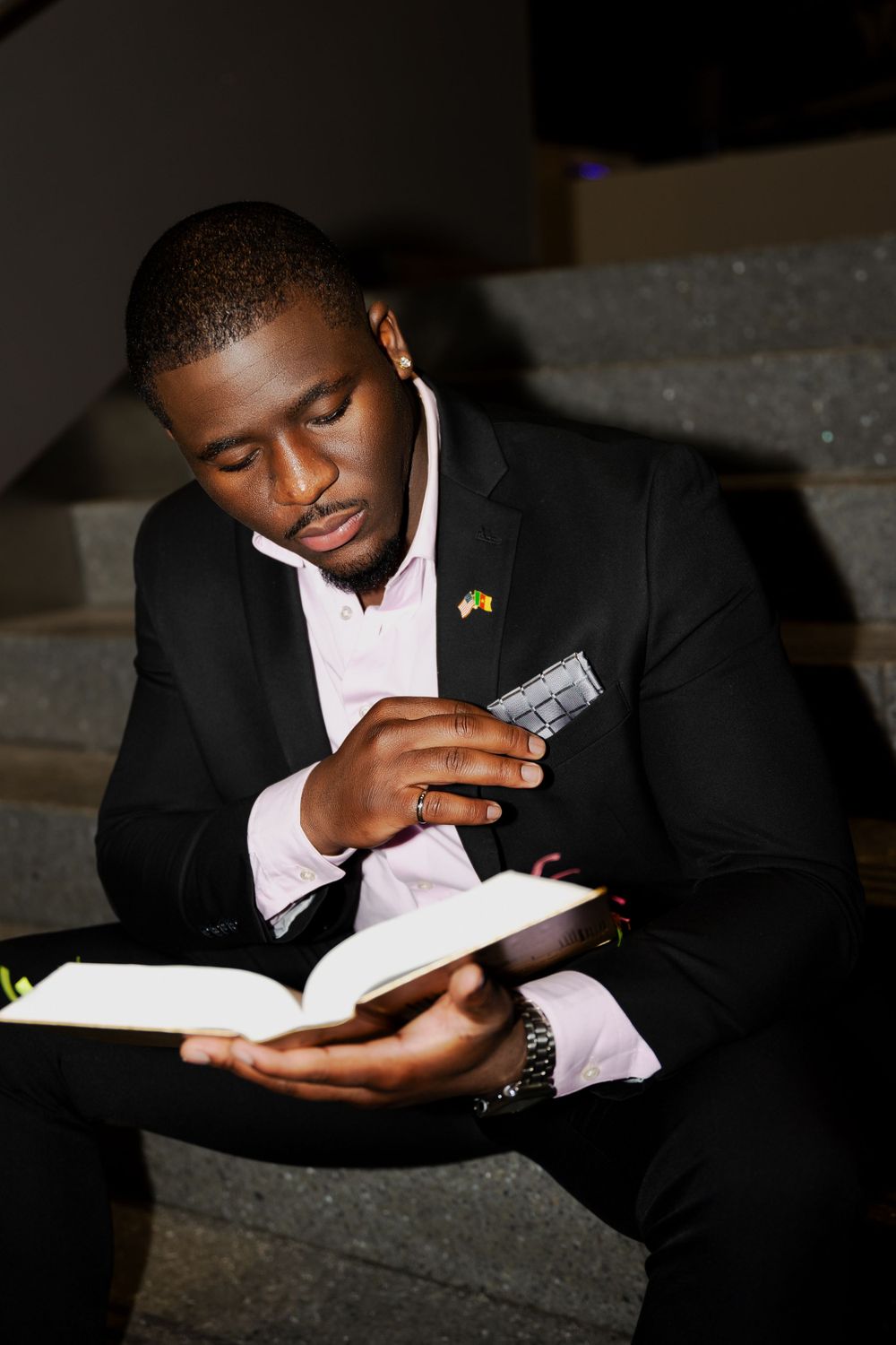 Person in business attire studying intently on staircase.