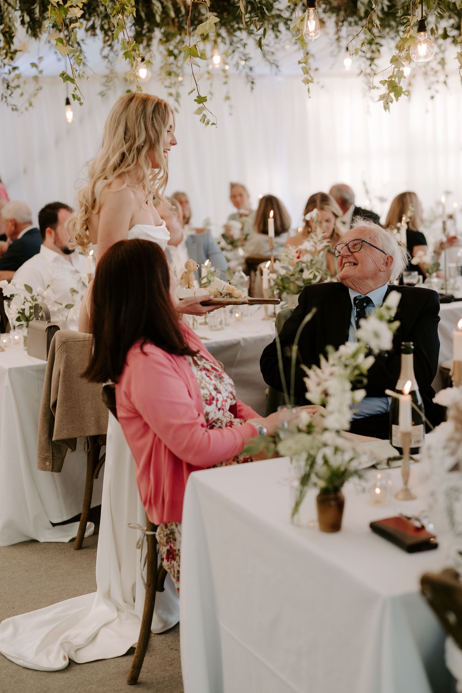 bride and grandfather laughing together during wedding breakfast at hamswell house wedding in bath