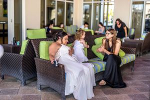 Group gathered on comfortable outdoor seating during social event.