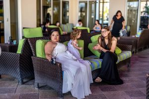 Casual conversation between guests on outdoor patio furniture at social event.