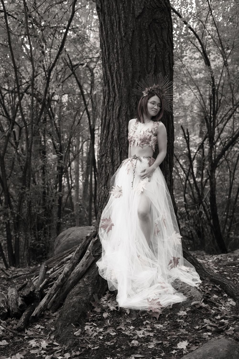 A haunting scene of a figure in a white dress standing among dark trees in a misty forest setting.