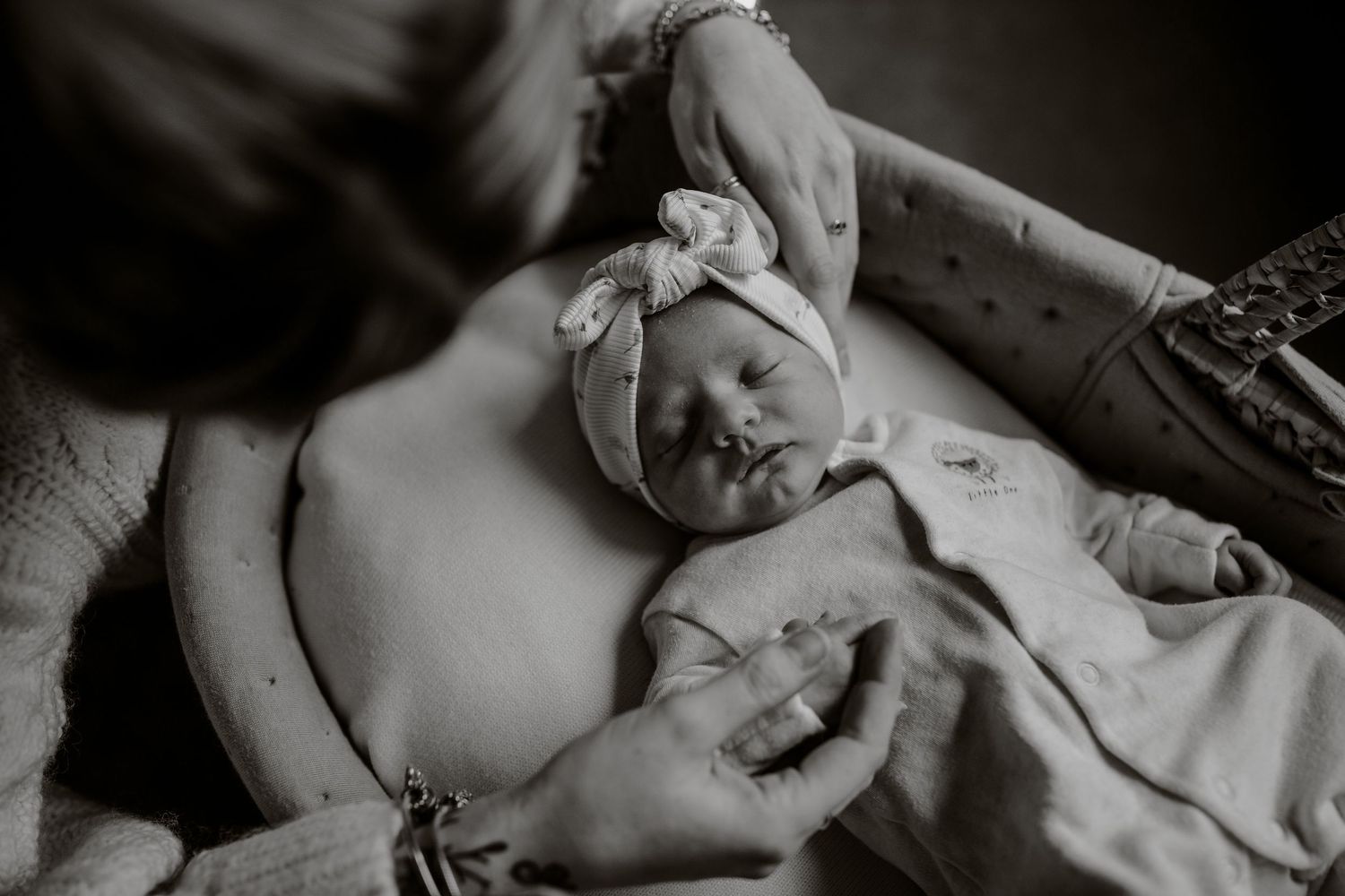 A black and white photo montage shows intimate moments between parent and newborn baby in hospital setting.