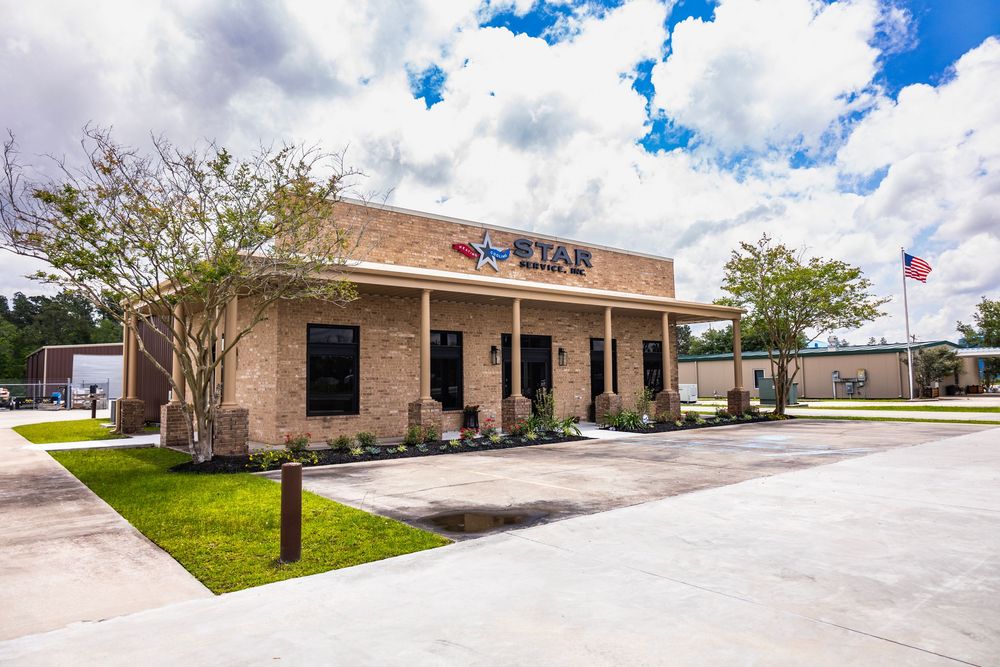 Wide angle view of a commercial office building with Star branding under partly cloudy skies.