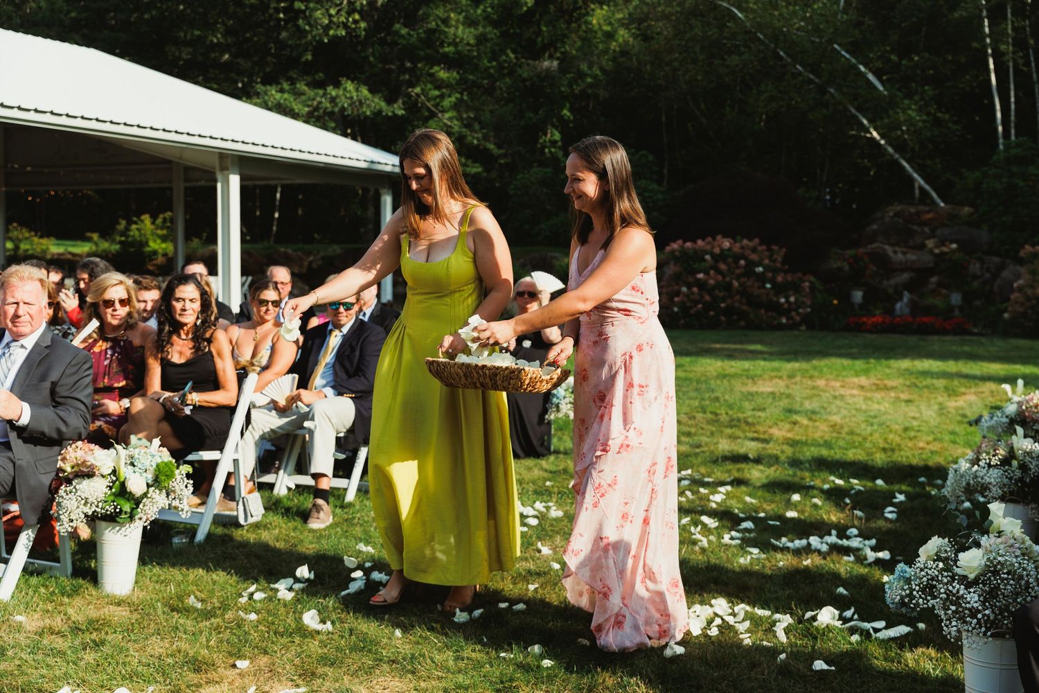 Wedding celebration with attendees in formal attire enjoying an outdoor garden reception.