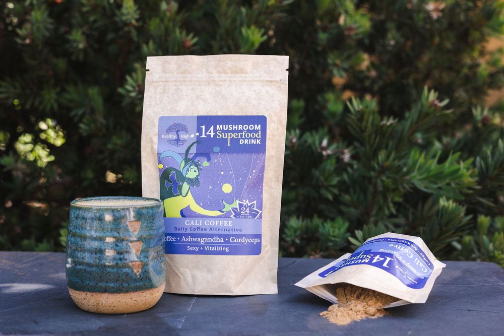 Handcrafted ceramic bowls and tea bags displayed on a wooden surface in natural outdoor lighting.