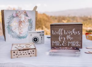 Wedding signage and decorative elements arranged on a white table.