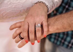 Close-up shots of hands displaying wedding rings and jewelry against a light background.