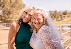 Casual outdoor celebration with people in white lace and western attire.