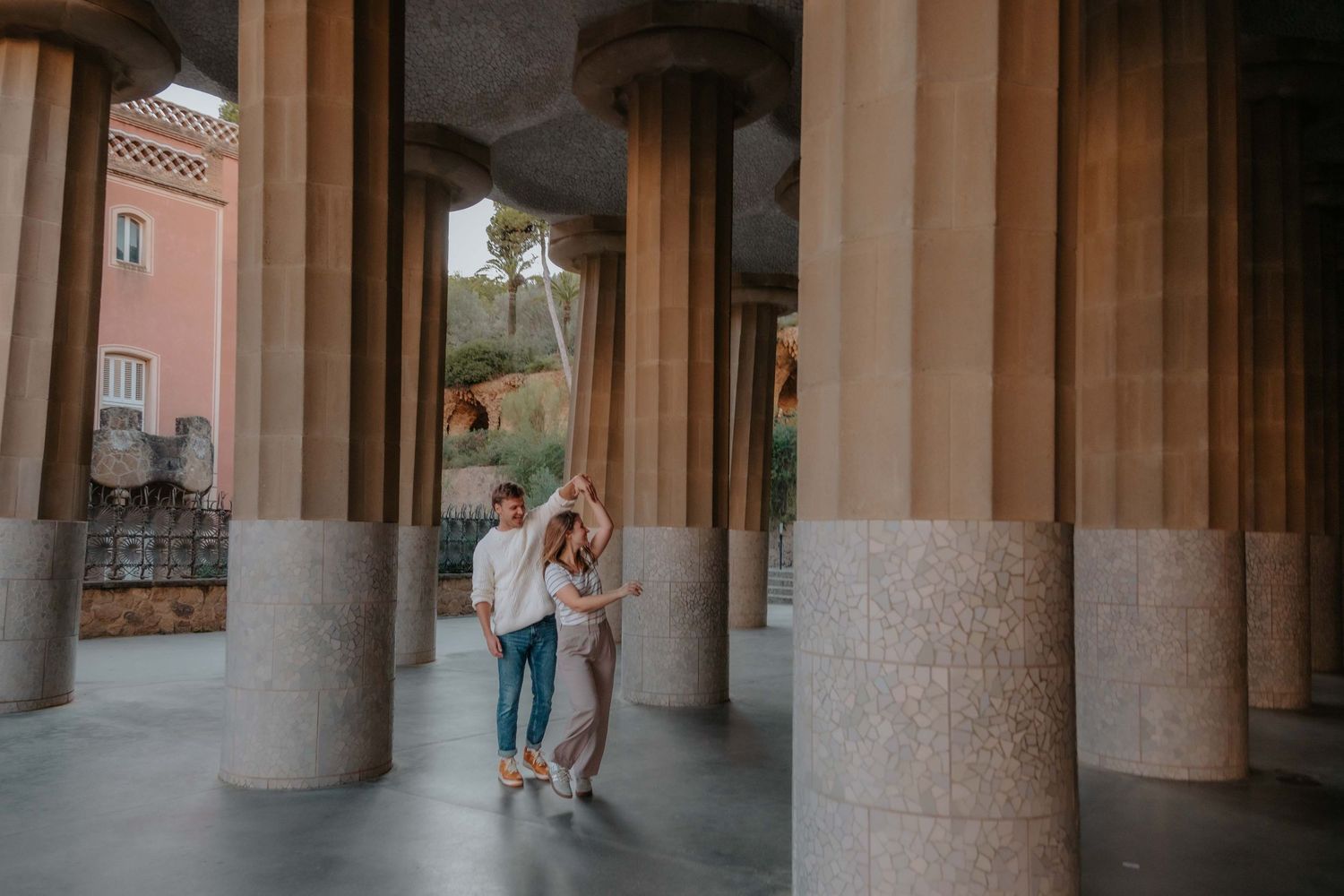 Surprise proposal moment with colorful mosaic background in Barcelona.